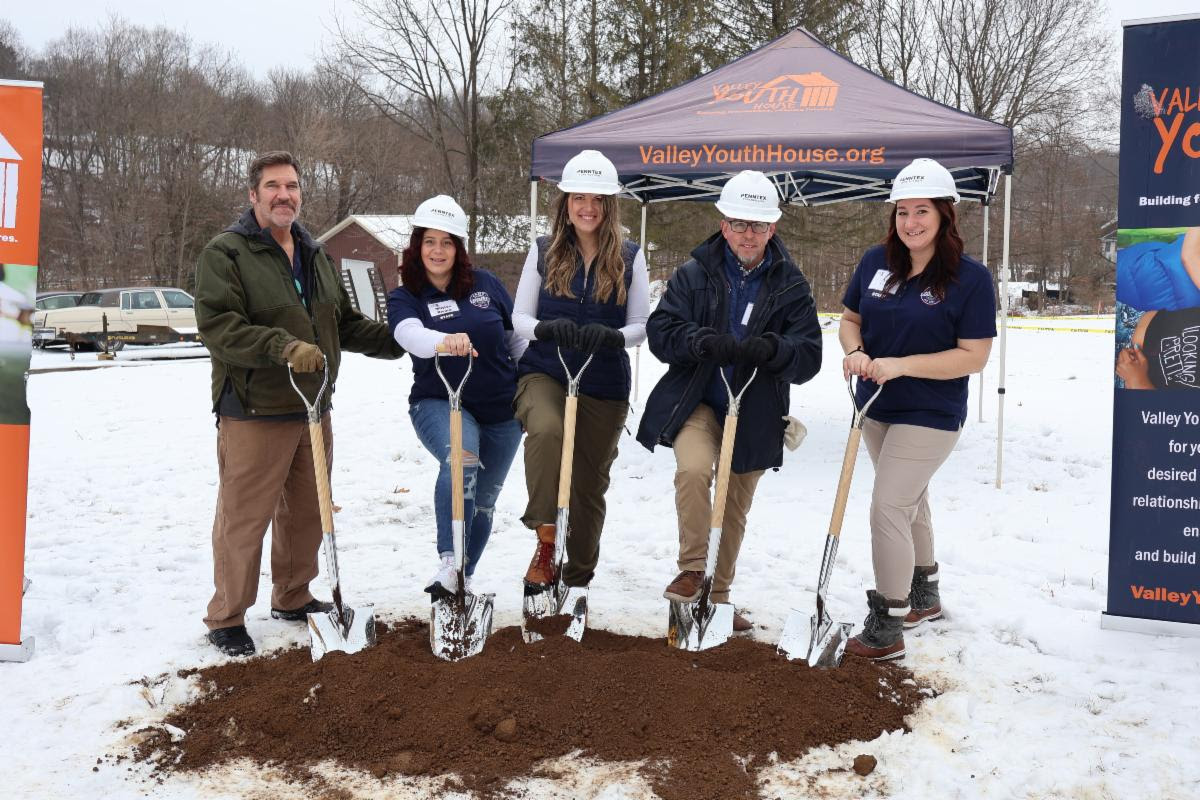 A group of people digging in the snow Description automatically generated