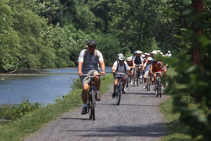 A group of people riding bicycles on a trail

Description automatically generated