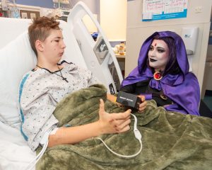 Anita Sergent, aka Raven, who is also a St Luke's photographer and Humble Hero has a chat with Anthony Murphy, 15 at St. Luke's Children's Hospital on Friday morning.