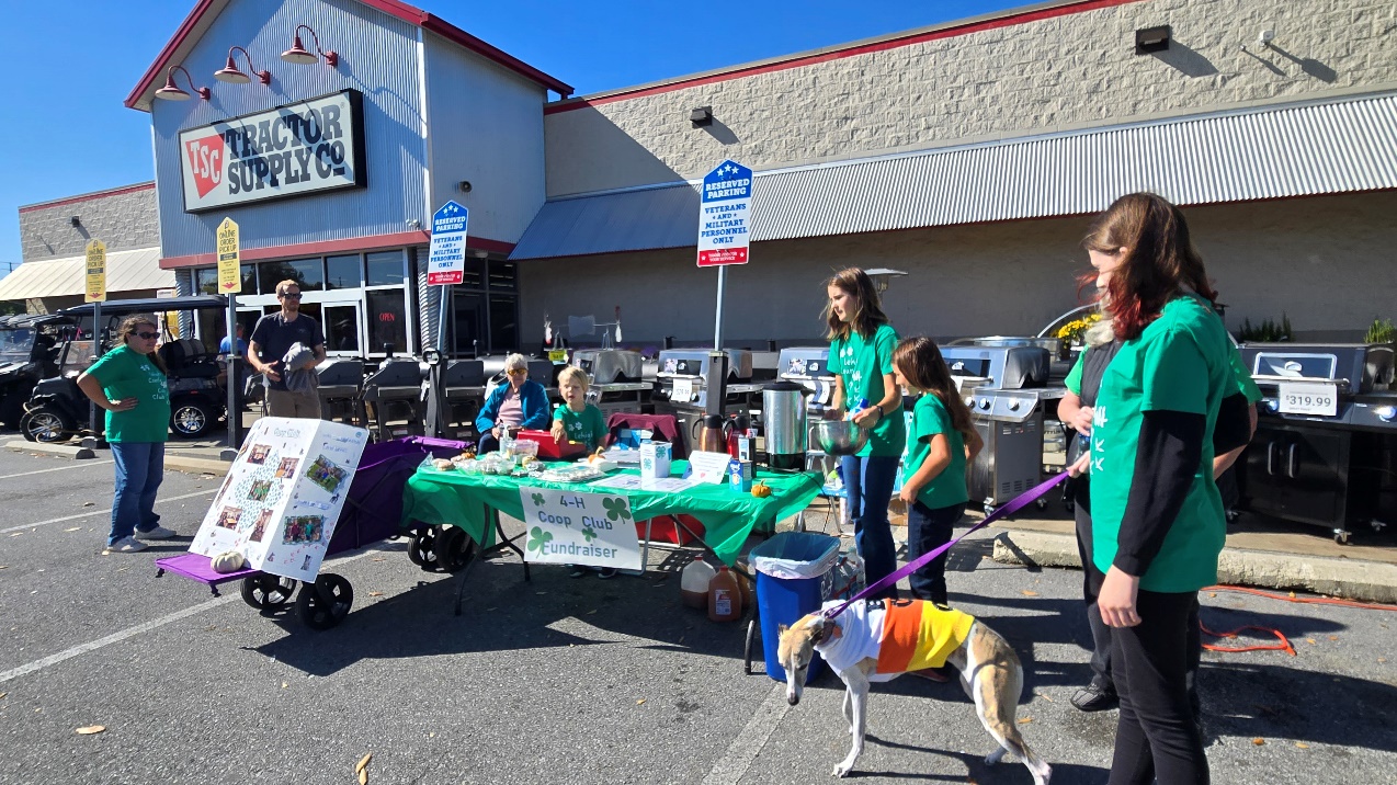 A group of people standing outside a store

Description automatically generated